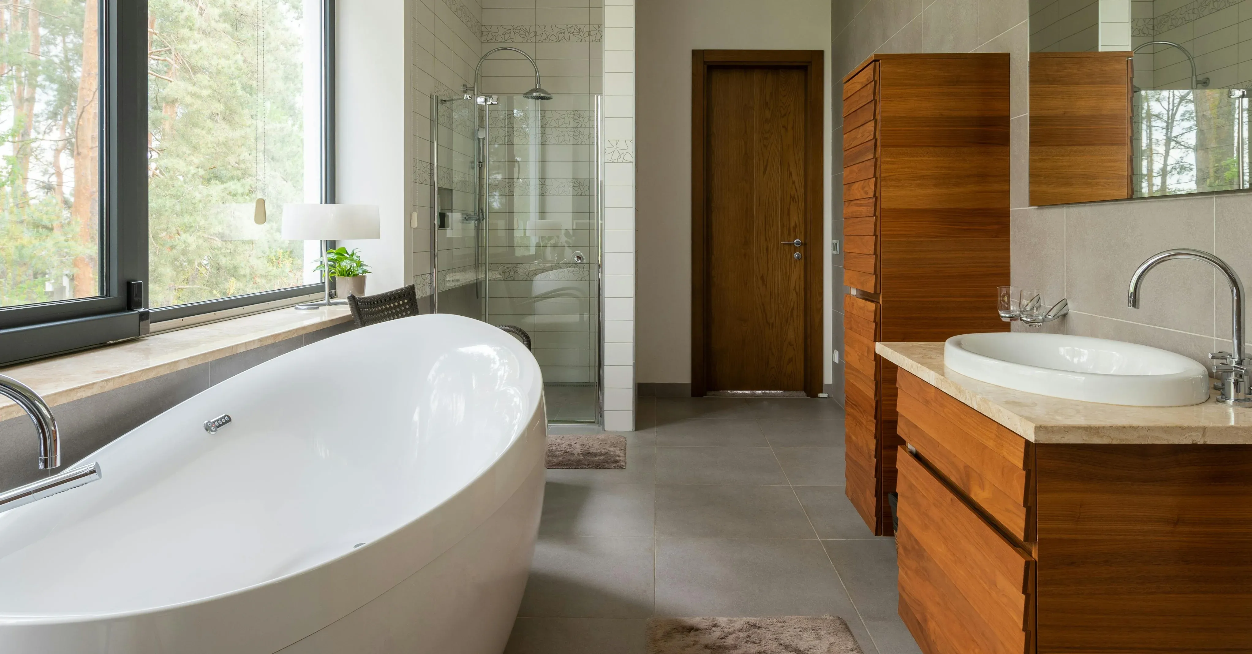 Modern bathroom renovation with freestanding bath and timber vanity