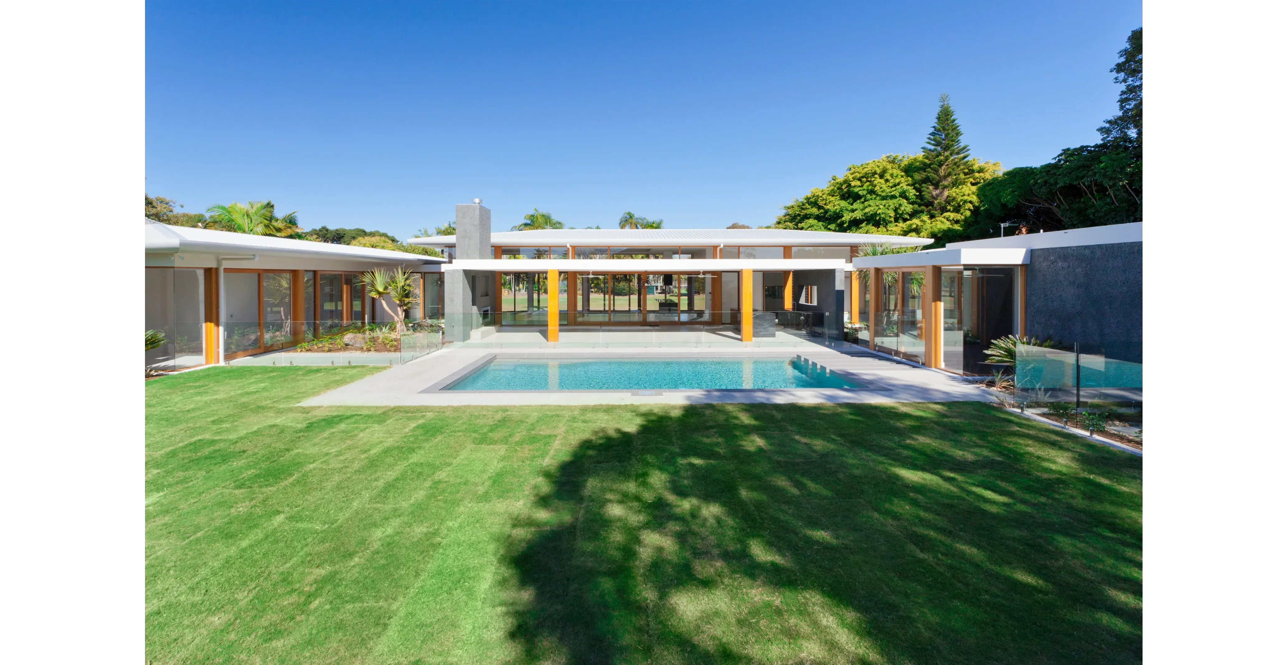 Rectangular concrete pool with glass fencing in Australia