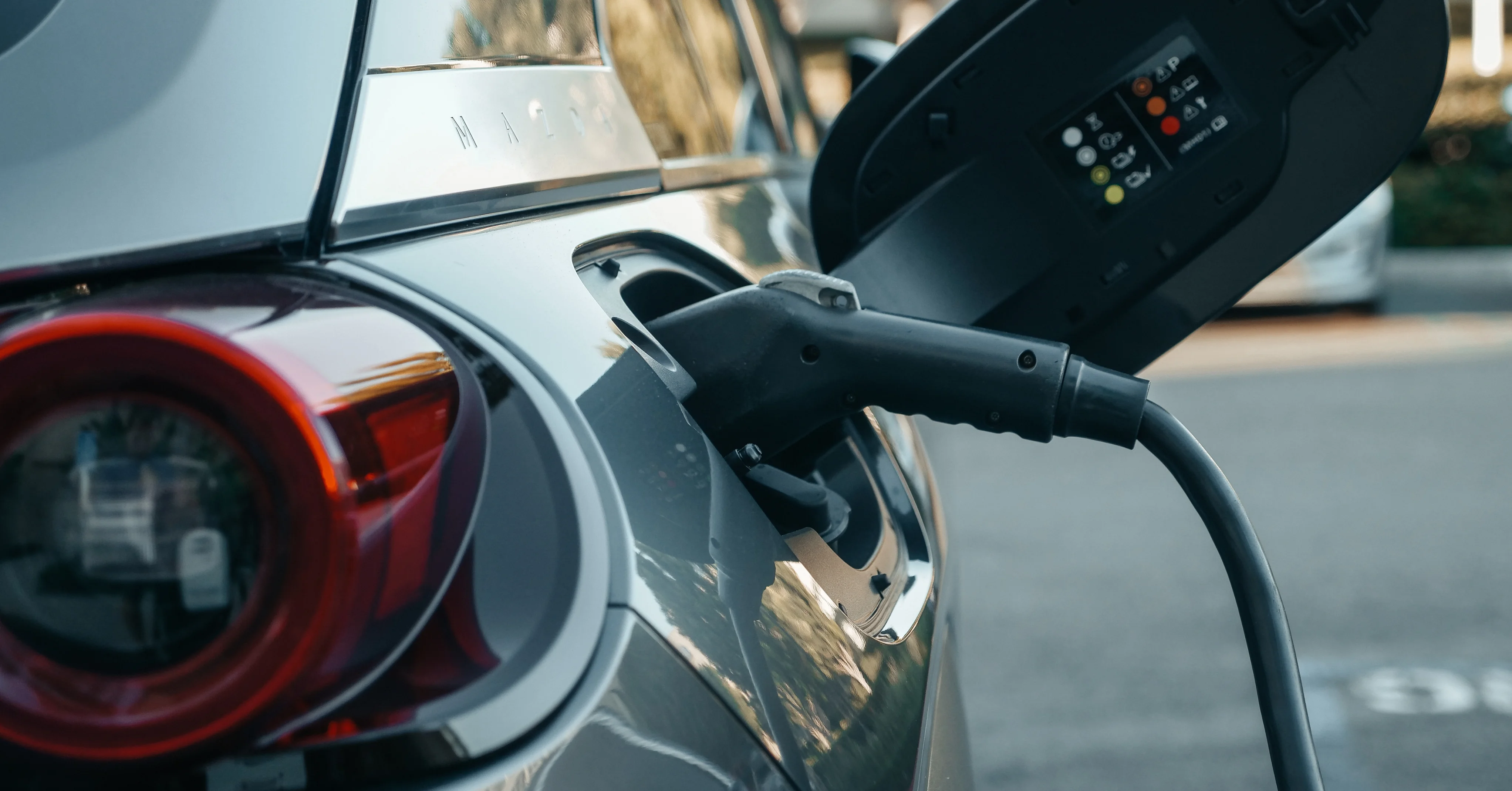 EV charger connector plugged into electric vehicle in {suburbData.name}